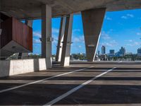 the view from inside a parking garage into buildings in the city center in the sun