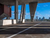 the view from inside a parking garage into buildings in the city center in the sun