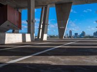 the view from inside a parking garage into buildings in the city center in the sun