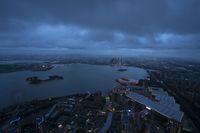 a view from the sky of london at night, with a large city in the background