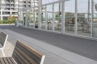 a white bench sitting on top of a sidewalk in front of tall buildings or office