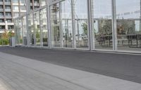 a white bench sitting on top of a sidewalk in front of tall buildings or office