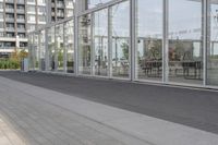 a white bench sitting on top of a sidewalk in front of tall buildings or office