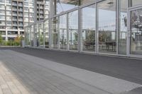 a white bench sitting on top of a sidewalk in front of tall buildings or office