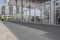 a white bench sitting on top of a sidewalk in front of tall buildings or office