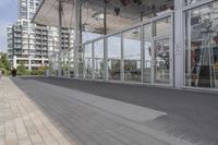 a white bench sitting on top of a sidewalk in front of tall buildings or office