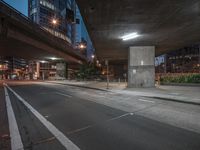 a large concrete structure next to a street and highway at night or day with no traffic