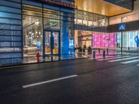 people walk outside a shopping mall that has been converted into a building in the evening