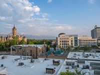 several large empty parking spaces in the city with buildings nearby in front of them -