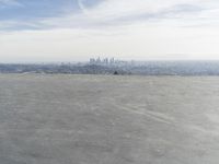 Cityscape Skyline Overlooking Asphalt Plain with Calm Sea
