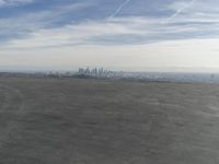 Cityscape Skyline Overlooking Asphalt Plain with Calm Sea
