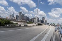 a freeway filled with lots of buildings and cars on it's side under a blue sky