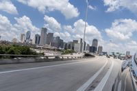 a freeway filled with lots of buildings and cars on it's side under a blue sky