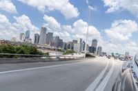 a freeway filled with lots of buildings and cars on it's side under a blue sky