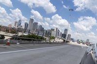 a freeway filled with lots of buildings and cars on it's side under a blue sky