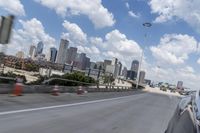 a freeway filled with lots of buildings and cars on it's side under a blue sky