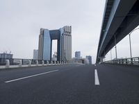 some very tall buildings near some big road bridges and buildings with a highway that is open