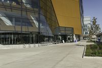 a view of a building with several chairs in it outside of a building outside the fence