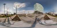 this is a photograph of a building in a city taken upside down with a fisheye lens