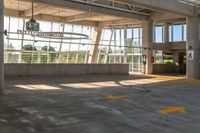 an empty parking lot in a large building with windows in front of it with a sign that reads huntington