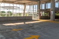 an empty parking lot in a large building with windows in front of it with a sign that reads huntington