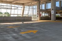 an empty parking lot in a large building with windows in front of it with a sign that reads huntington