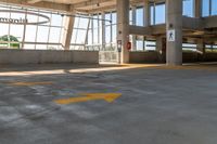 an empty parking lot in a large building with windows in front of it with a sign that reads huntington