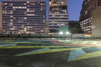 there is a lot of art on the concrete ground in the city at night,