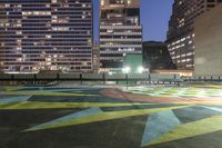 there is a lot of art on the concrete ground in the city at night,