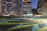 there is a lot of art on the concrete ground in the city at night,