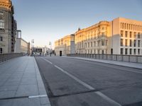 an empty city street with buildings and road signs on it's sides, one side is empty and the other is empty