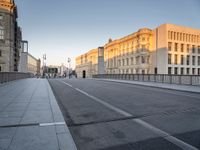 an empty city street with buildings and road signs on it's sides, one side is empty and the other is empty