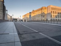 an empty city street with buildings and road signs on it's sides, one side is empty and the other is empty