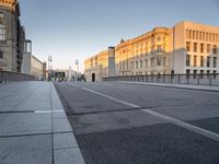 an empty city street with buildings and road signs on it's sides, one side is empty and the other is empty