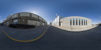 360 - vr image of buildings and road taken in front of them, with traffic lights on