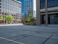 a street with a building near the building in the middle and on the left of which is a parking lot, as shown in this photo