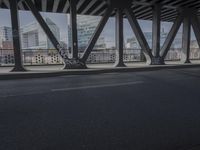 an image of a view out a window on the bridge, with traffic driving along it