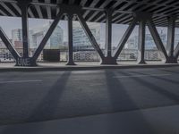 an image of a view out a window on the bridge, with traffic driving along it