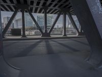 an image of a view out a window on the bridge, with traffic driving along it