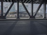 an image of a view out a window on the bridge, with traffic driving along it