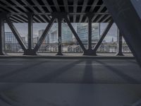 an image of a view out a window on the bridge, with traffic driving along it