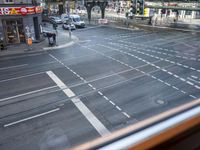 the view out the window on the road from the passenger platform in the city, people walking on the sidewalk, and cars
