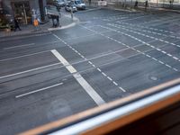 the view out the window on the road from the passenger platform in the city, people walking on the sidewalk, and cars