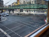 the view out the window on the road from the passenger platform in the city, people walking on the sidewalk, and cars