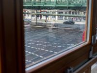 the view out the window on the road from the passenger platform in the city, people walking on the sidewalk, and cars