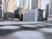 a view of the city through a roof deck overlooking the city's buildings on a clear day