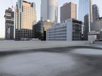 a view of the city through a roof deck overlooking the city's buildings on a clear day