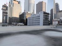 a view of the city through a roof deck overlooking the city's buildings on a clear day