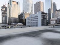 a view of the city through a roof deck overlooking the city's buildings on a clear day