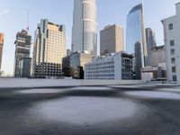 a view of the city through a roof deck overlooking the city's buildings on a clear day